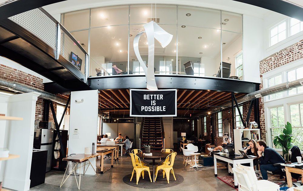 A shared office area with a mix of chair and table types for different working modes.