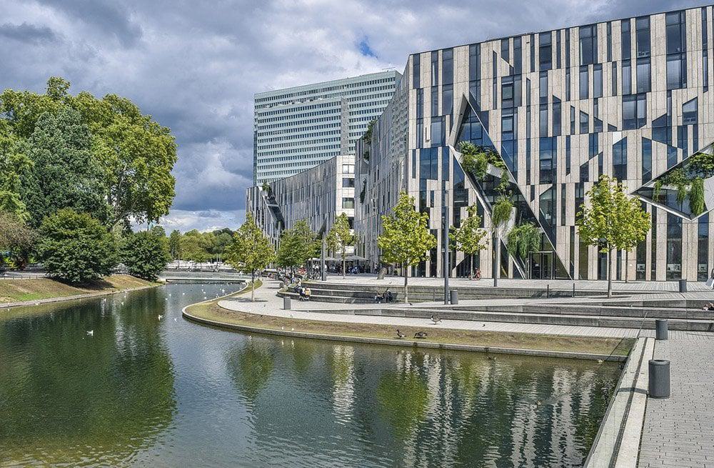 Curvy landscape against angular buildings