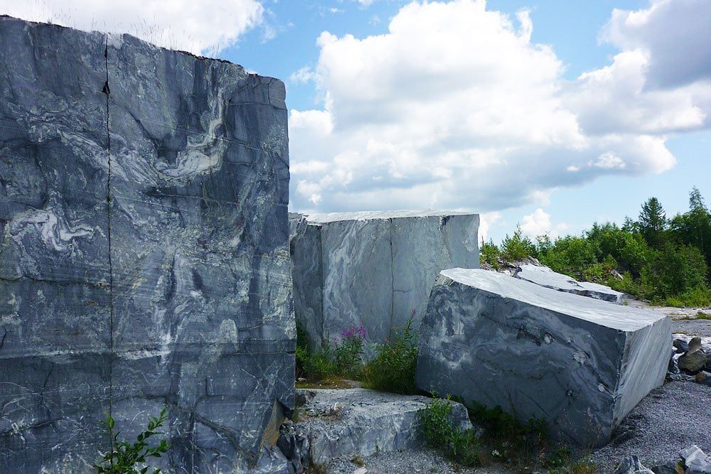 quarried blocks of marble stacked at a quarry.