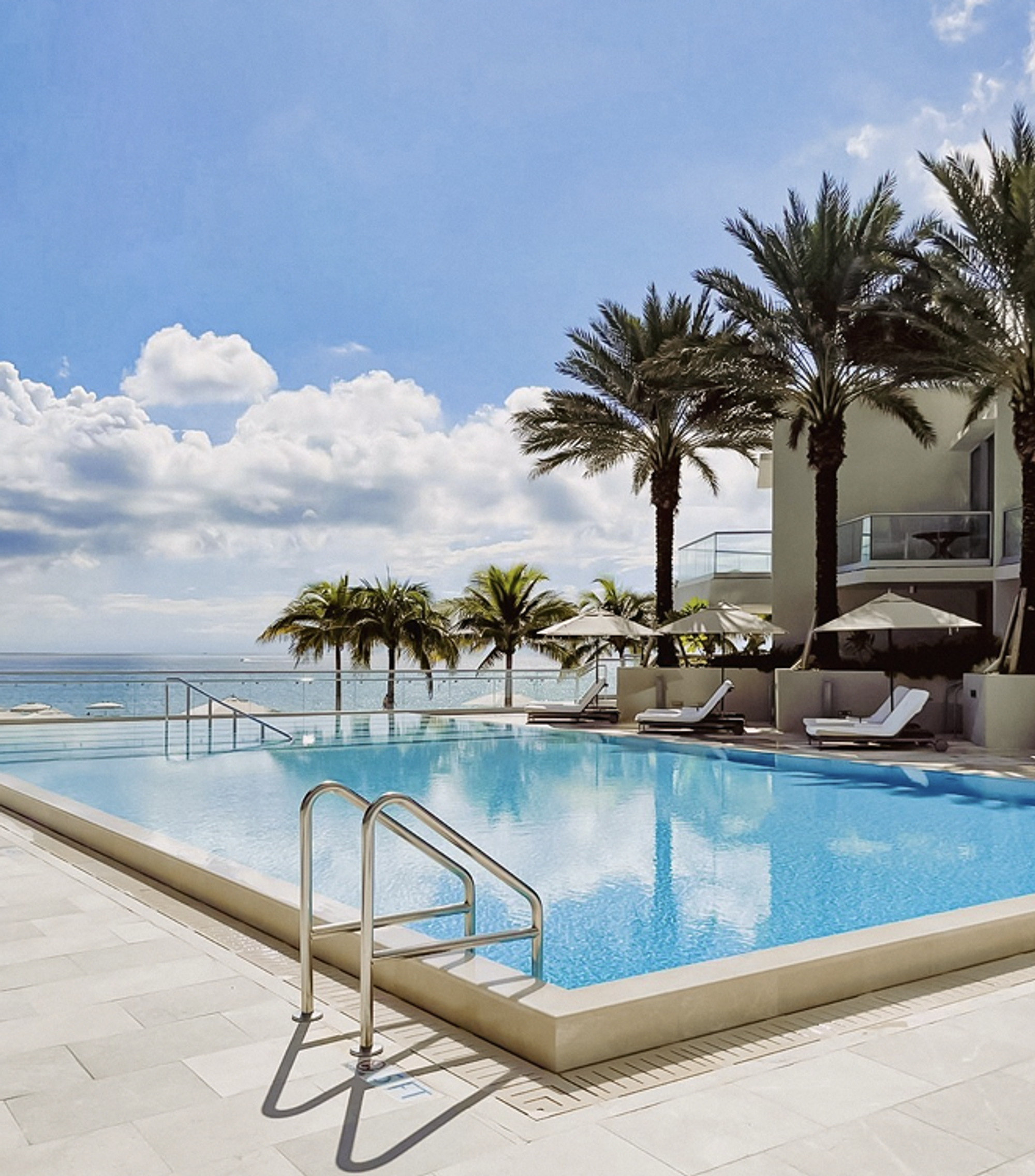 Jonite decorative pool grates around a large swimming pool