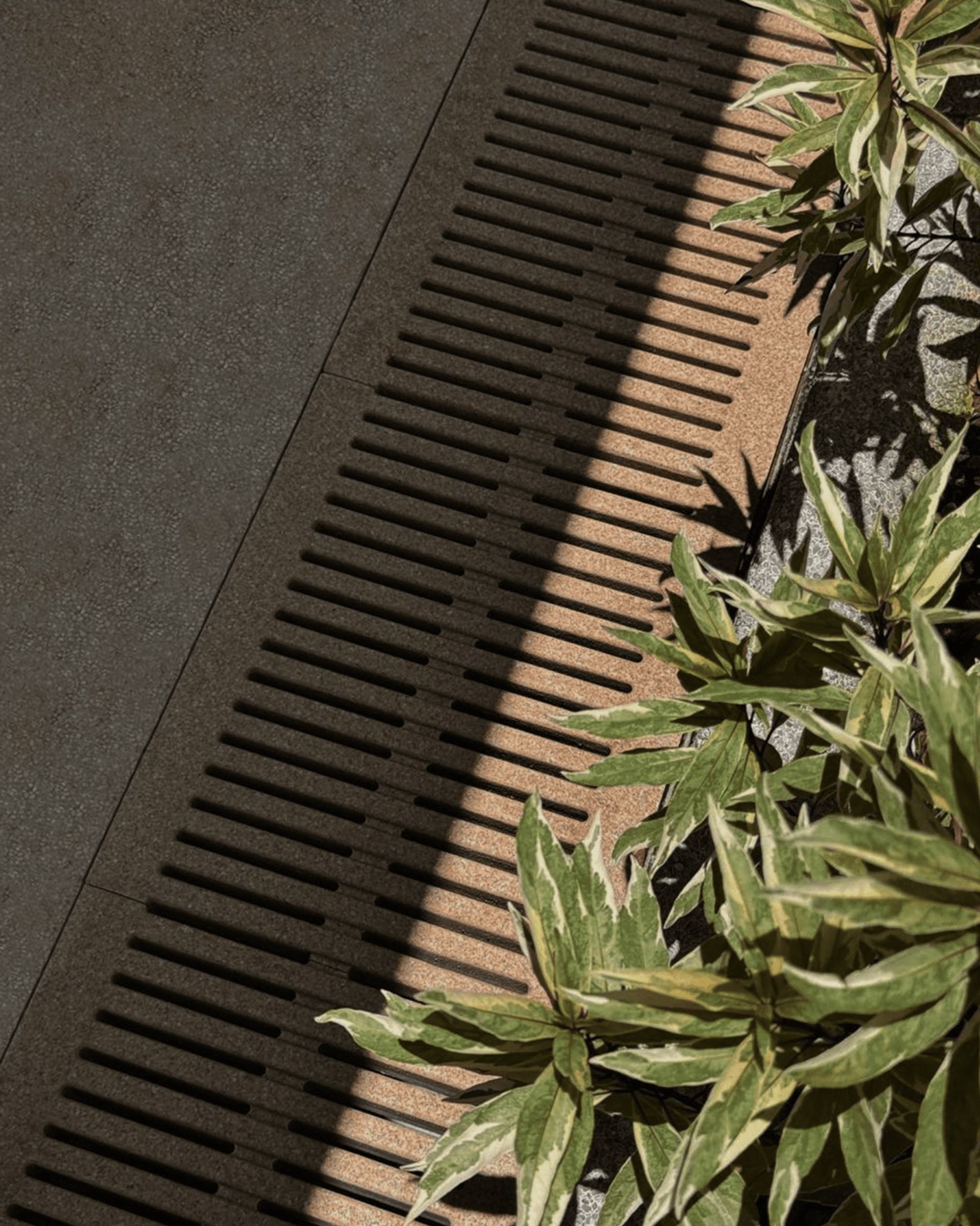 Jonite trench drain grate next to greenery